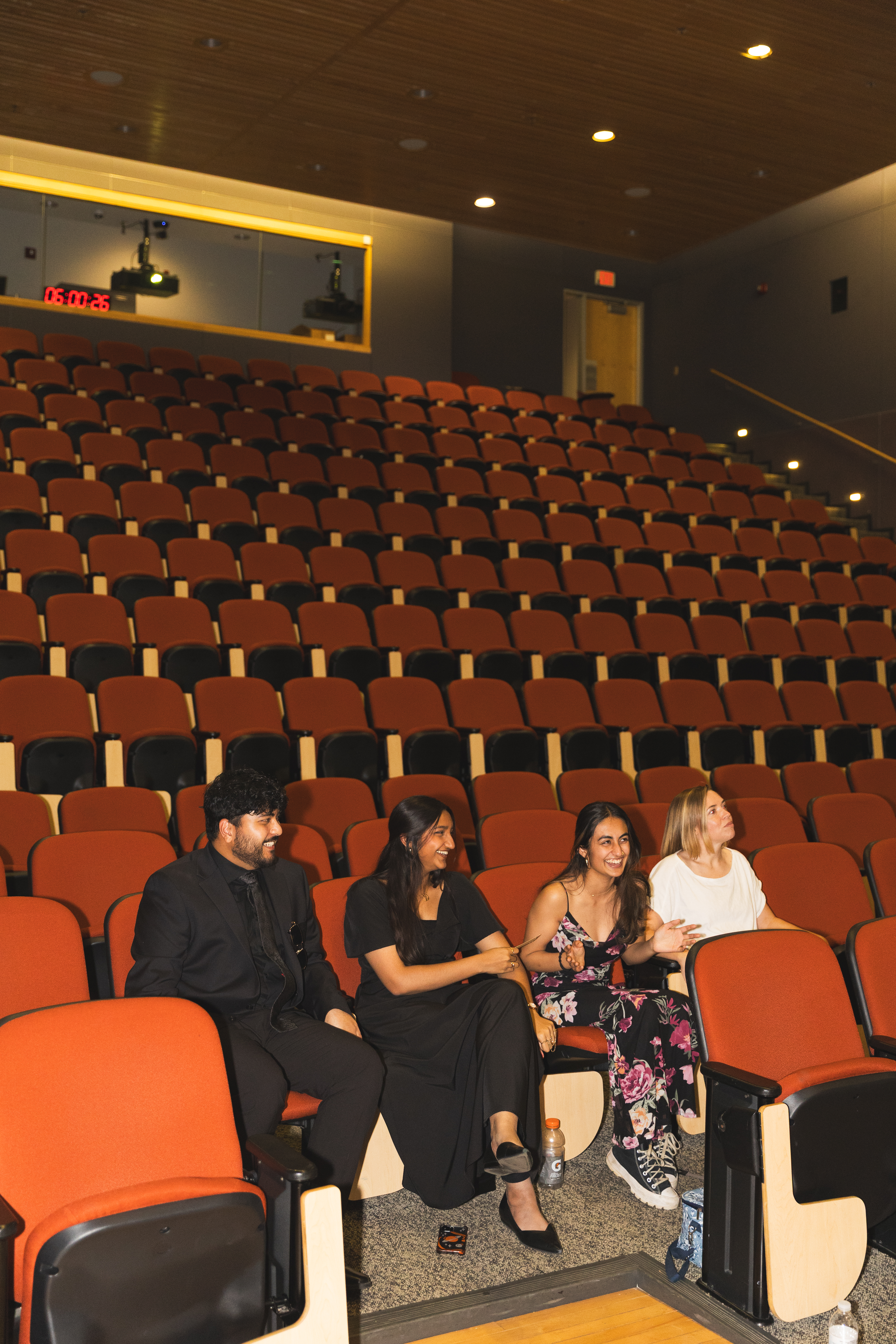 Keya laughing alongside her J584 Resilience team in the empty theater before the premiere of their documentary